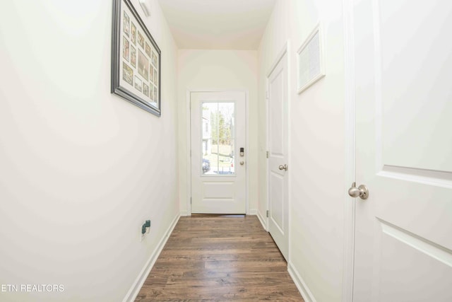 entryway featuring dark wood-style floors and baseboards