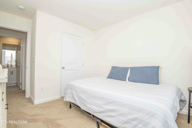 bedroom featuring light colored carpet and baseboards