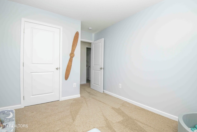 unfurnished bedroom featuring baseboards and carpet floors