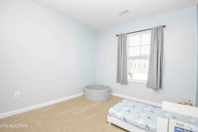 bedroom with visible vents, baseboards, and carpet flooring