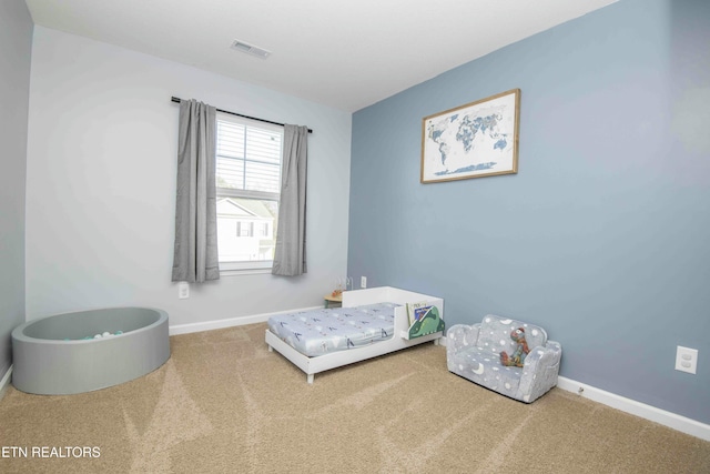 bedroom with visible vents, baseboards, and carpet floors