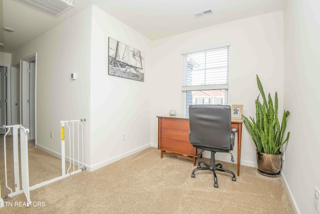 carpeted office with baseboards and visible vents