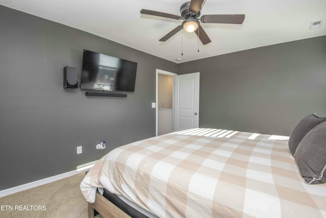 carpeted bedroom featuring visible vents, baseboards, and a ceiling fan