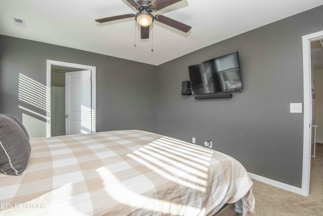 carpeted bedroom with visible vents, baseboards, and ceiling fan