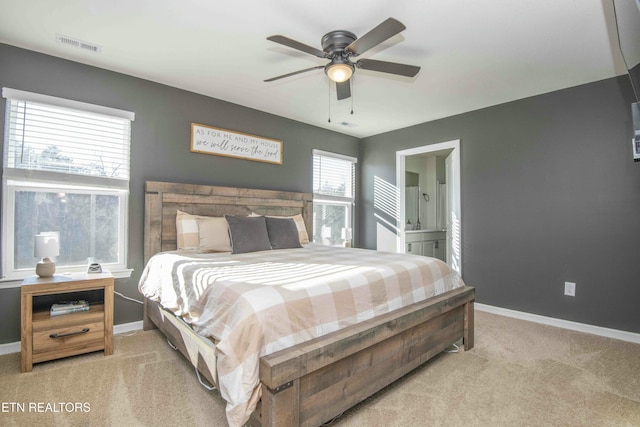 bedroom with visible vents, light colored carpet, and baseboards