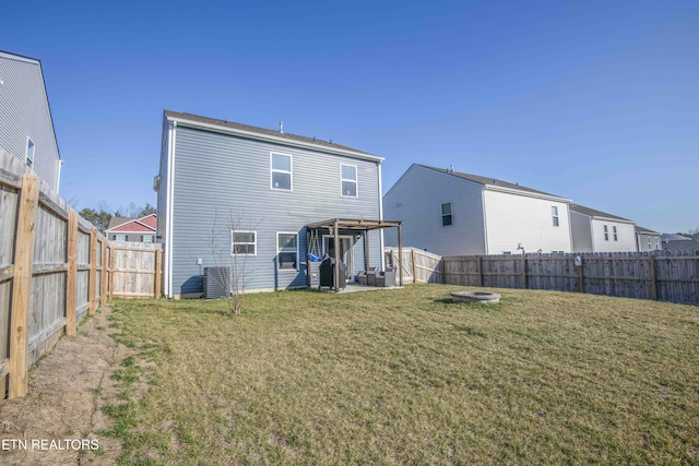 back of house featuring a yard, central air condition unit, a patio, and a fenced backyard