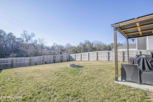 view of yard with a fire pit and a fenced backyard