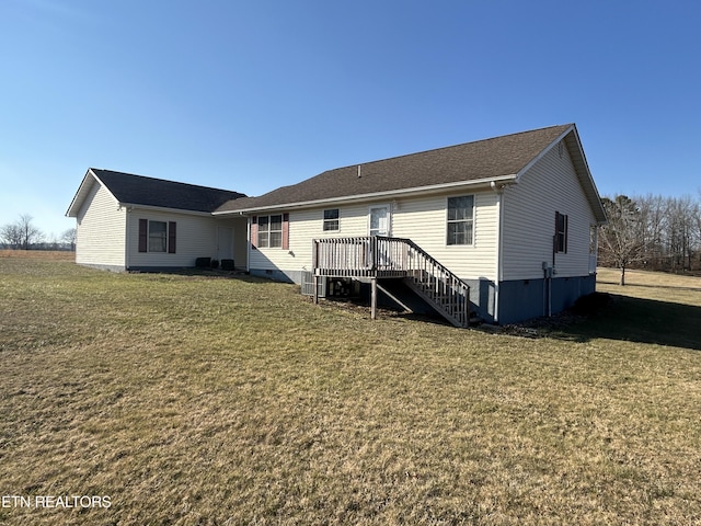 rear view of property featuring crawl space, a yard, a wooden deck, and stairs