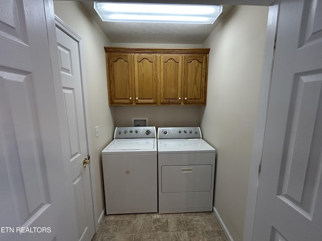 clothes washing area with baseboards, cabinet space, and separate washer and dryer