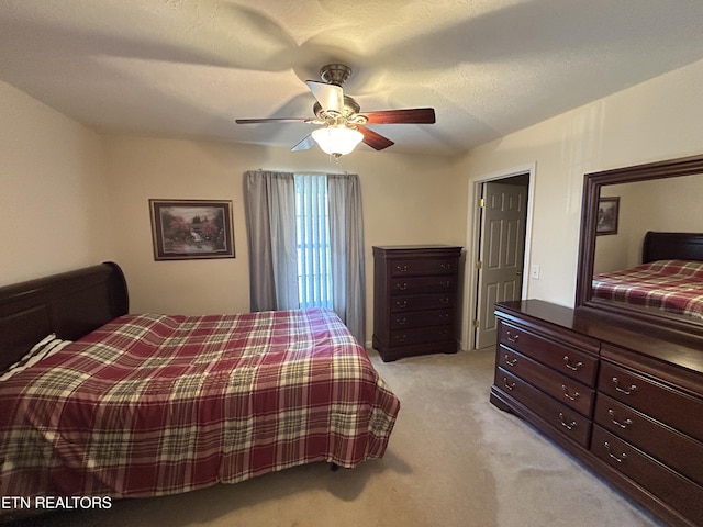 bedroom featuring light colored carpet and ceiling fan