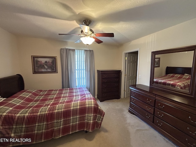 bedroom with a ceiling fan and light colored carpet