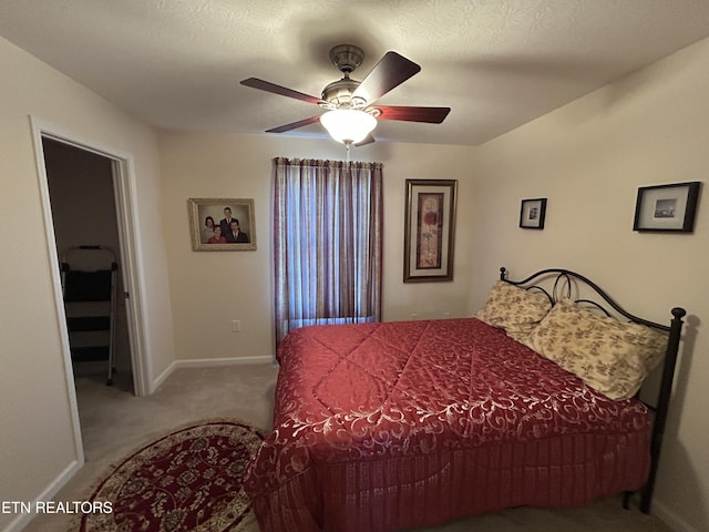 carpeted bedroom featuring a ceiling fan and baseboards