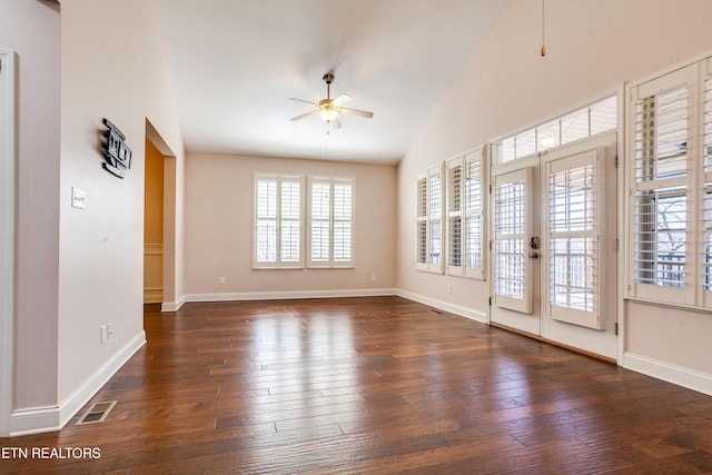 interior space with visible vents, baseboards, hardwood / wood-style floors, and a ceiling fan