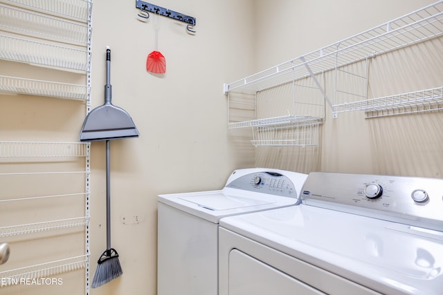 washroom featuring washer and clothes dryer and laundry area