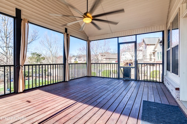 unfurnished sunroom featuring ceiling fan and vaulted ceiling