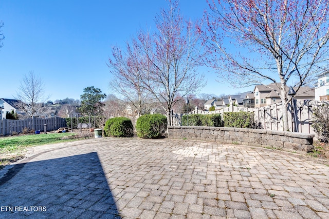 view of patio featuring a residential view and fence private yard