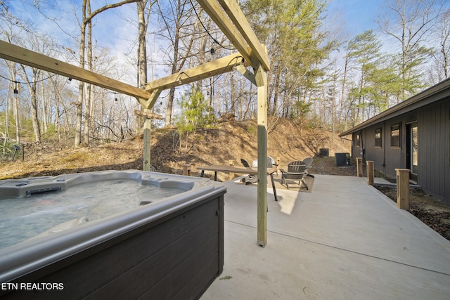 view of patio / terrace with central air condition unit and a hot tub