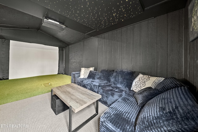 carpeted cinema with lofted ceiling and golf simulator