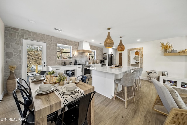 dining area featuring visible vents, recessed lighting, and light wood-type flooring