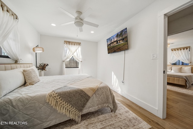 bedroom with a ceiling fan, recessed lighting, wood finished floors, and baseboards