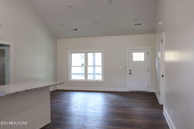 unfurnished living room featuring visible vents, baseboards, and dark wood-type flooring