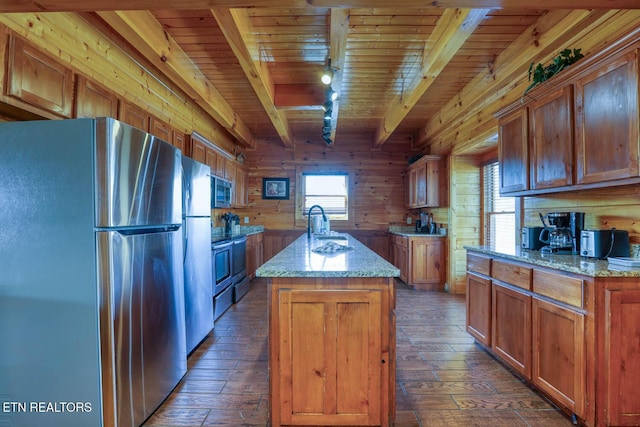 kitchen featuring beam ceiling, dark wood finished floors, appliances with stainless steel finishes, wooden ceiling, and wood walls