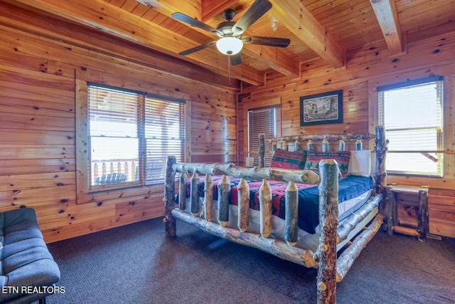 bedroom with beam ceiling, carpet flooring, wooden ceiling, and wood walls