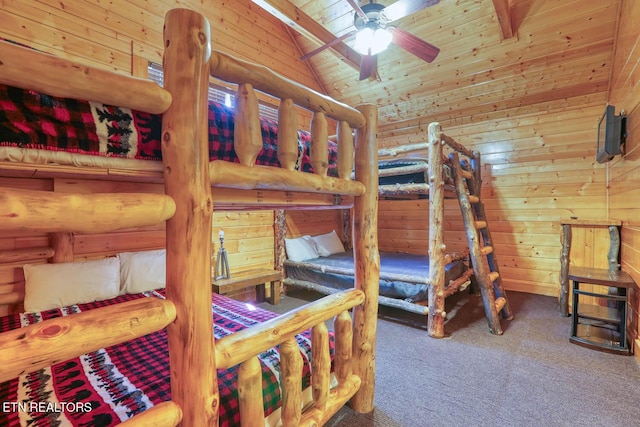 bedroom featuring lofted ceiling, wooden walls, wooden ceiling, and carpet floors