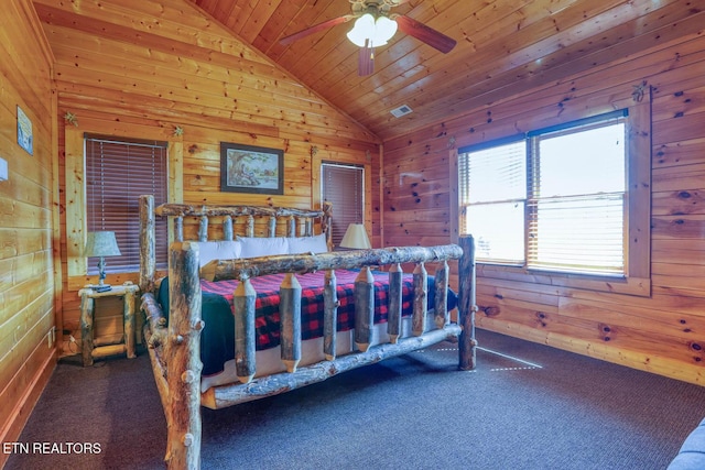 carpeted bedroom featuring visible vents, wooden walls, wooden ceiling, and vaulted ceiling