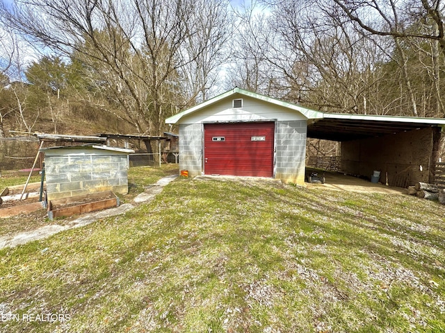 view of pole building with a lawn and driveway