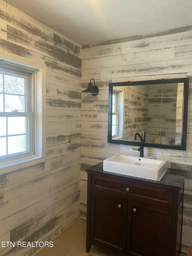 bathroom featuring tile patterned floors, a textured ceiling, and vanity