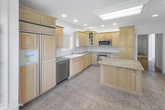 kitchen with a sink, crown molding, light brown cabinets, and stainless steel appliances