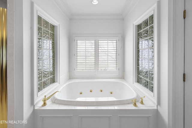 full bathroom featuring a tub with jets, ornamental molding, and a healthy amount of sunlight