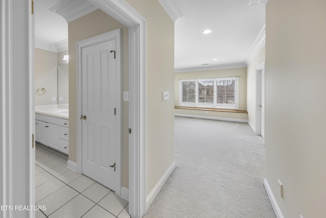 hall featuring recessed lighting, light colored carpet, baseboards, and ornamental molding