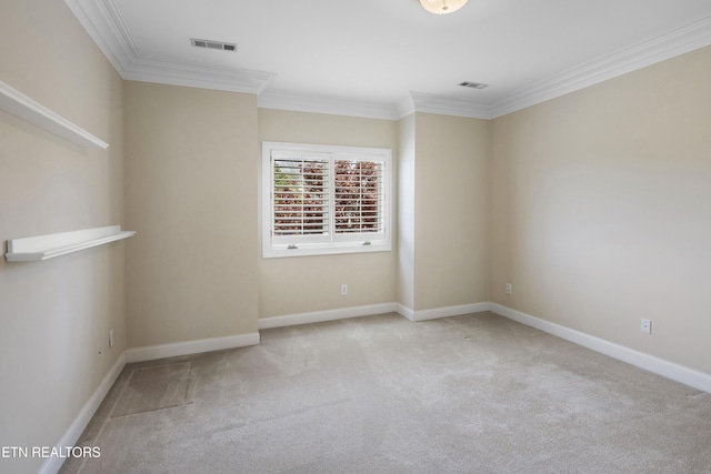 carpeted empty room with ornamental molding, visible vents, and baseboards