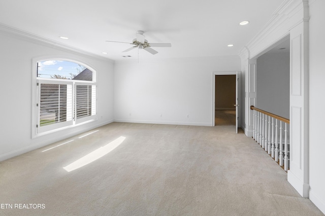 carpeted spare room featuring crown molding, ceiling fan, recessed lighting, and baseboards