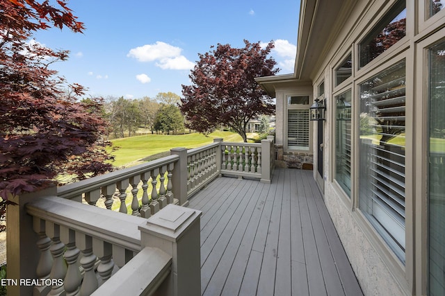 wooden deck with a lawn