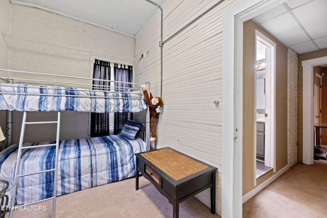 carpeted bedroom featuring a paneled ceiling