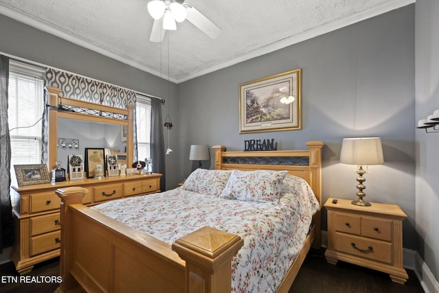 bedroom featuring ornamental molding, a ceiling fan, a textured ceiling, dark wood finished floors, and baseboards