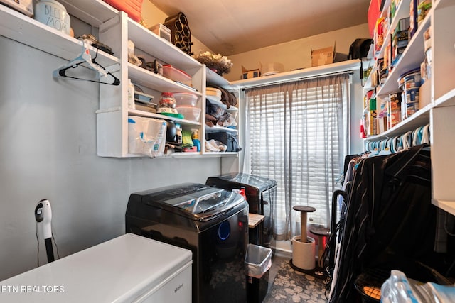 clothes washing area with washing machine and clothes dryer and laundry area