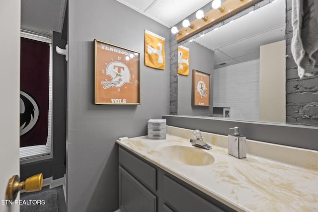 bathroom with vanity and a paneled ceiling