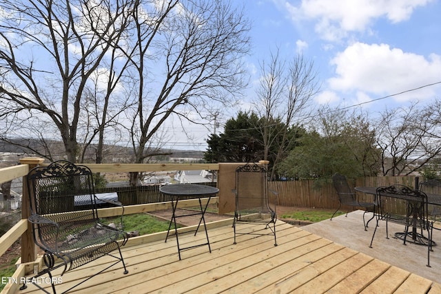 deck featuring outdoor dining space and fence