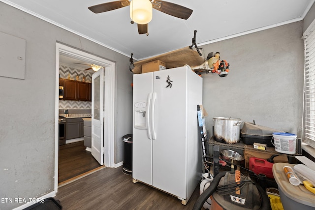 kitchen with a ceiling fan, gas stove, dark wood-type flooring, white fridge with ice dispenser, and crown molding