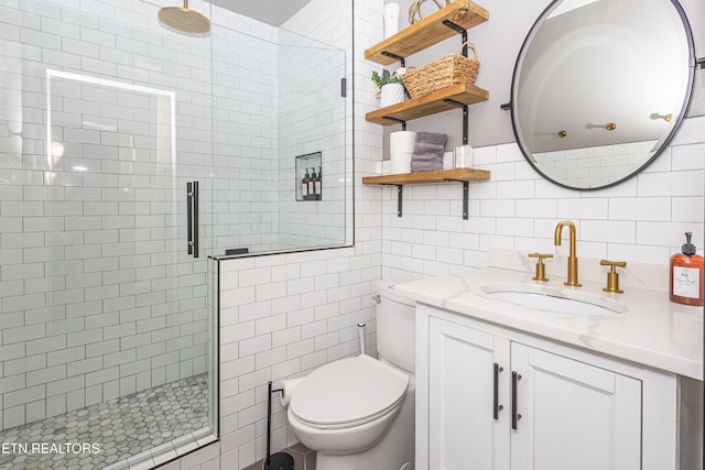 full bathroom featuring toilet, tile walls, a shower stall, decorative backsplash, and vanity