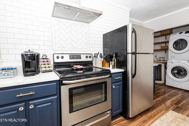 kitchen with ventilation hood, stacked washing maching and dryer, blue cabinetry, appliances with stainless steel finishes, and tasteful backsplash