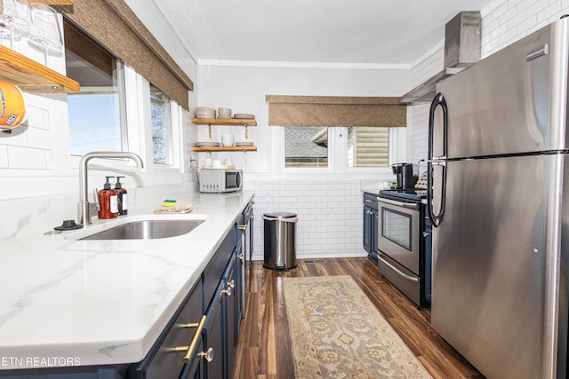 kitchen with blue cabinets, a sink, open shelves, dark wood-style floors, and appliances with stainless steel finishes