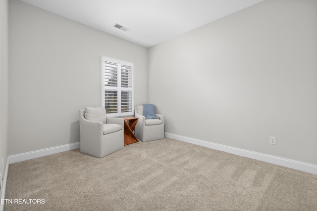 sitting room with visible vents, baseboards, and carpet