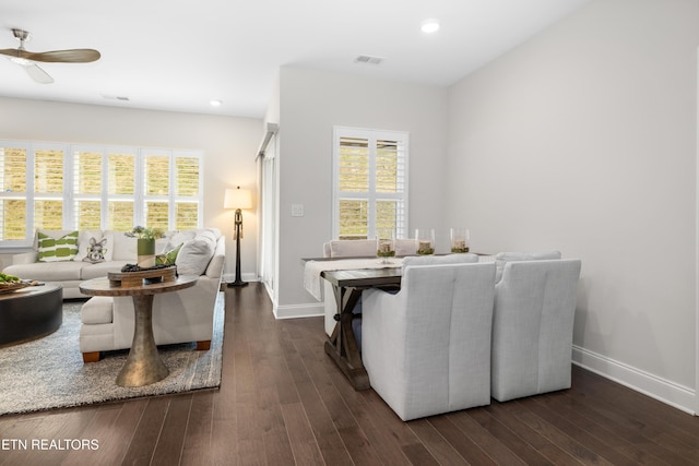 living room with recessed lighting, baseboards, and dark wood-style flooring