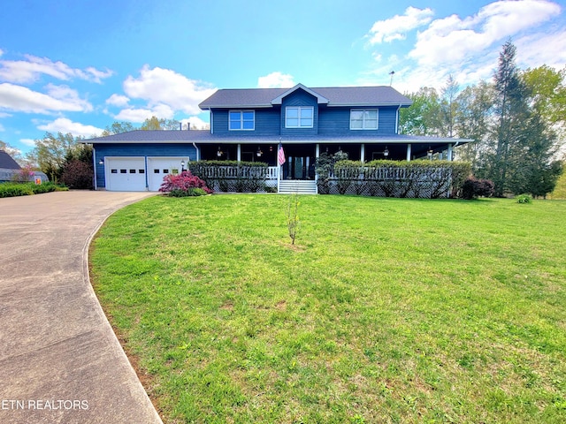 view of front facade with a porch, an attached garage, a front lawn, and concrete driveway