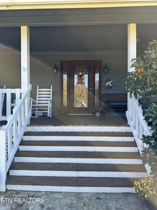 doorway to property featuring covered porch